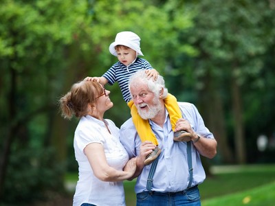 Little boy having fun with his grandparents in park